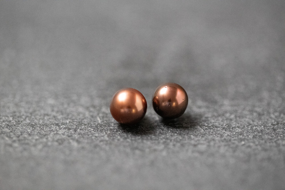 Zwei runde Frischwasserperlen in schokobrauner Farbe mit feinem Glanz