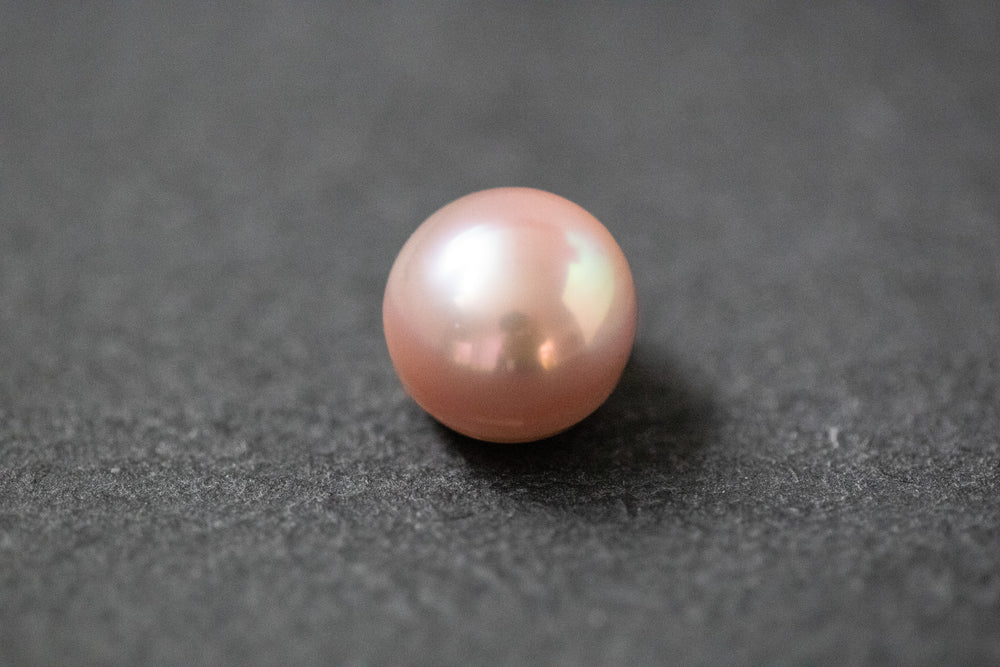 Zart rosafarbene, flach-runde Frischwasserperle mit seidigem Schimmer