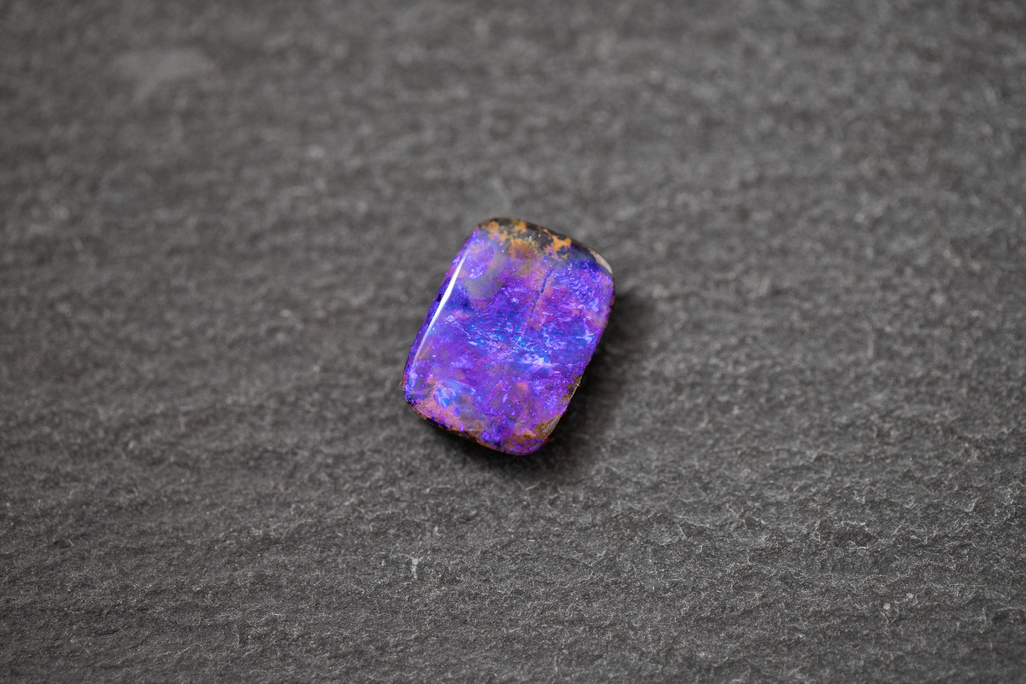 Boulderopal in Fantasieform mit intensivem Farbspiel in Violett und Blau – natürlicher Edelstein mit einzigartiger Struktur